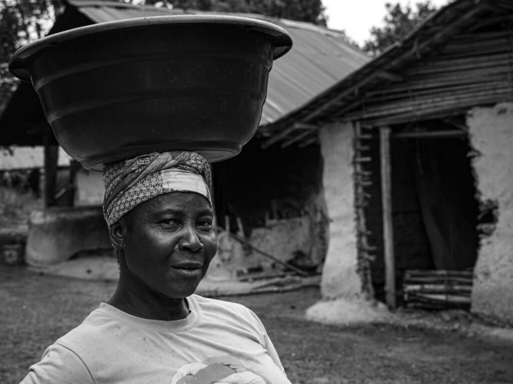 A woman carrying a basin on her head in Massatin