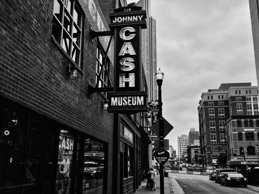 The Johnny Cash Museum sign in Nashville places the name of a celebrated musician amid the ordinary signage and buildings of the city.