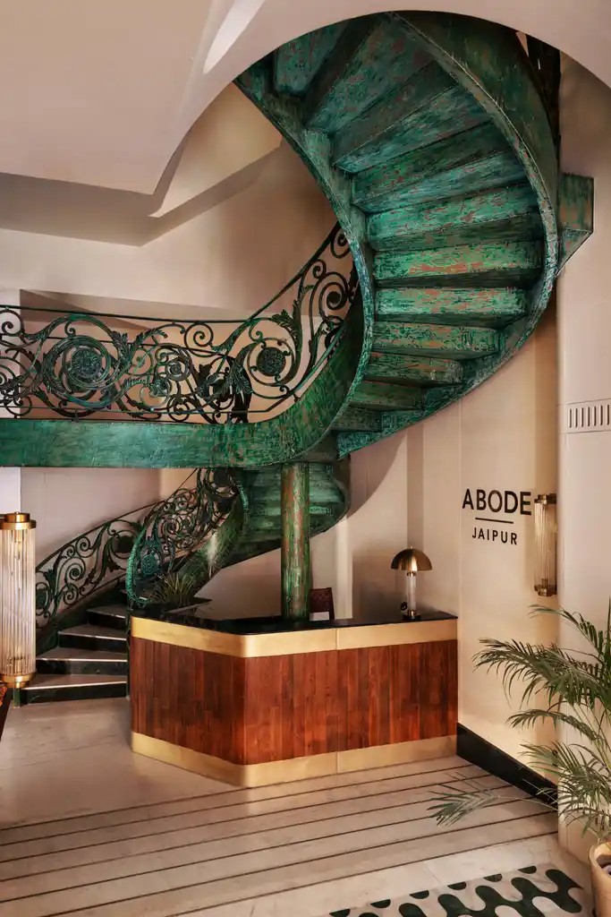 Reception at Abode Jaipur with the green wrought-iron spiral staircase