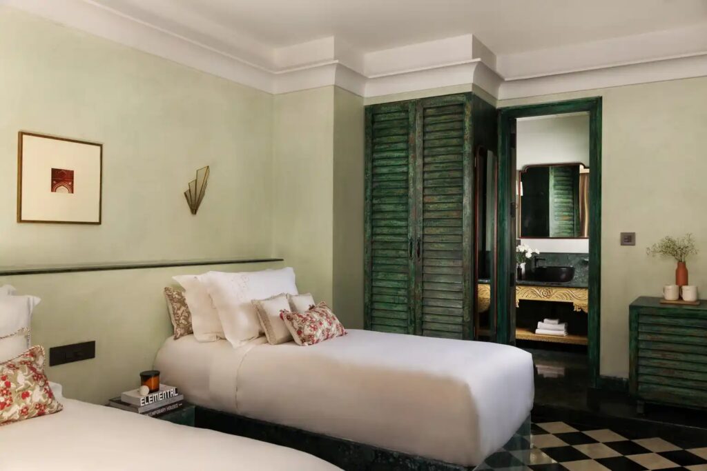Green guest room with louvred wardrobe at Abode Jaipur