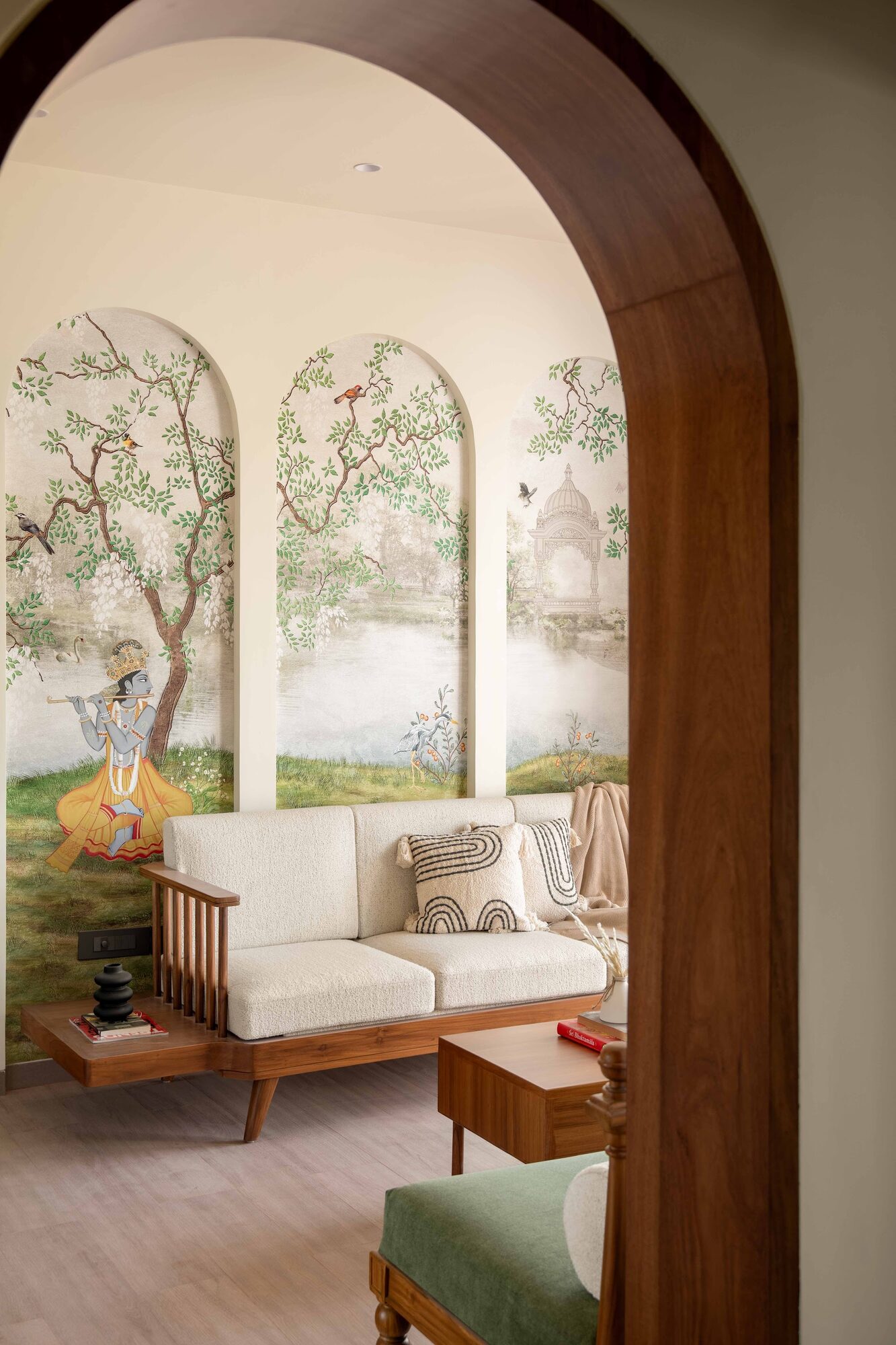 Living area with a custom wallpaper mural of Krishna playing the flute, The Divine नेस्ट, Vrindavan