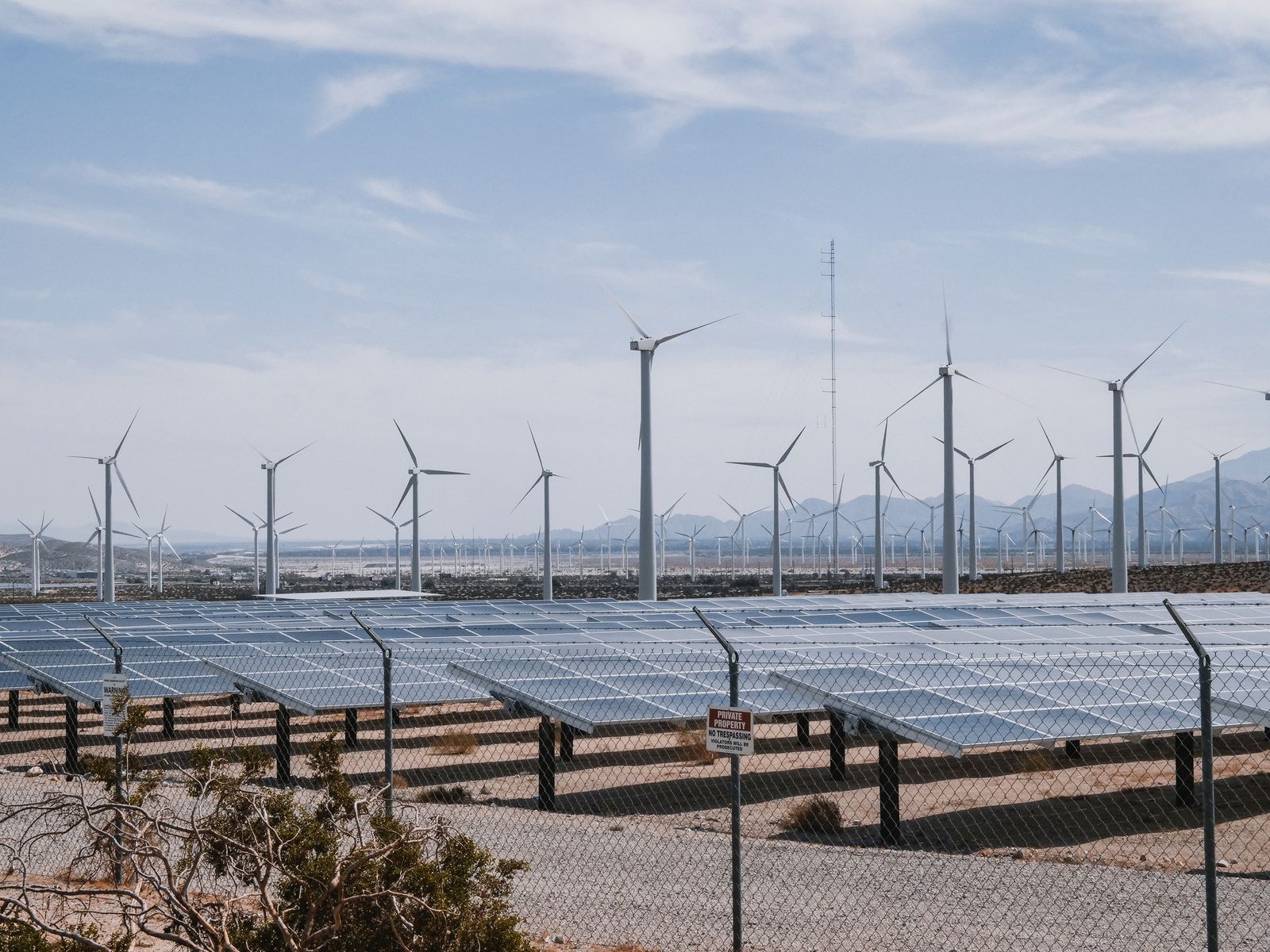 Wind turbines and solar panels in a renewable energy farm