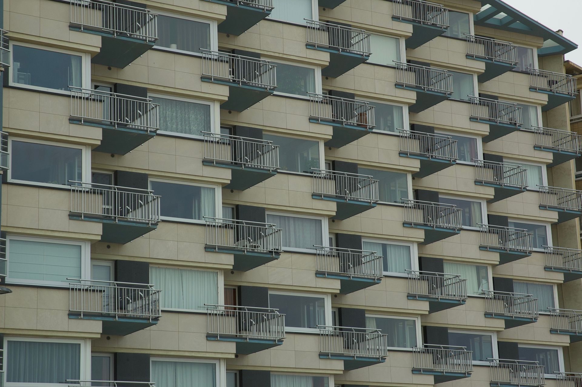 Repeating balconies of a dense residential block, raising questions of housing quality and health