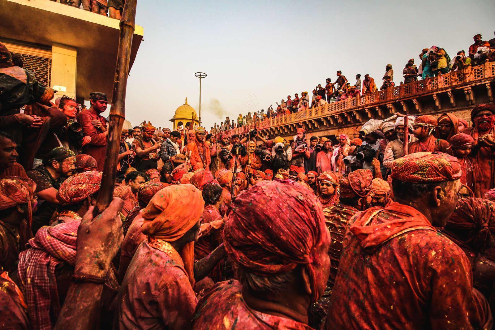 Crowd celebrating the Holi festival outdoors in India