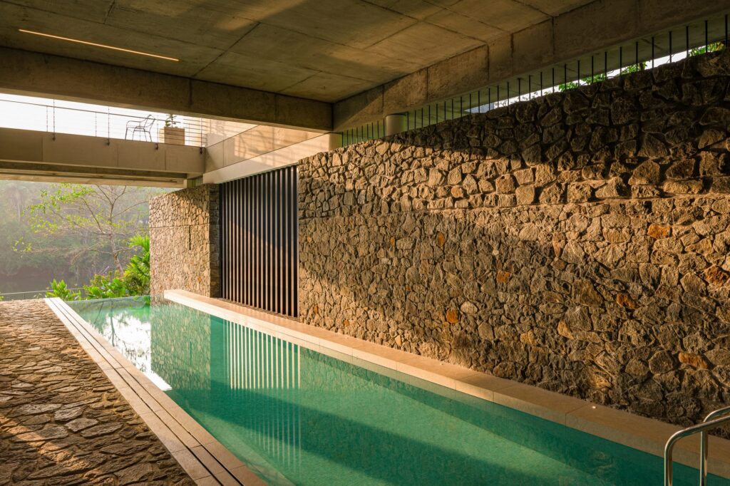 The pool, edged by a textured stone wall. Photo: Praveen Mohandas