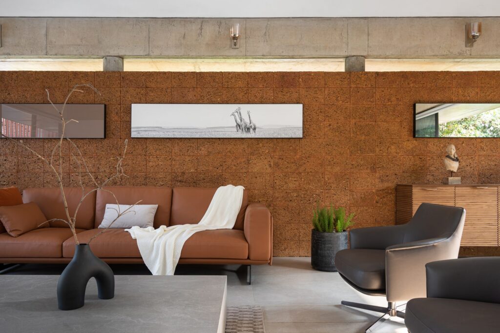 Exposed laterite walls give the formal living room its warmth. Photo: Turtle Arts Photography